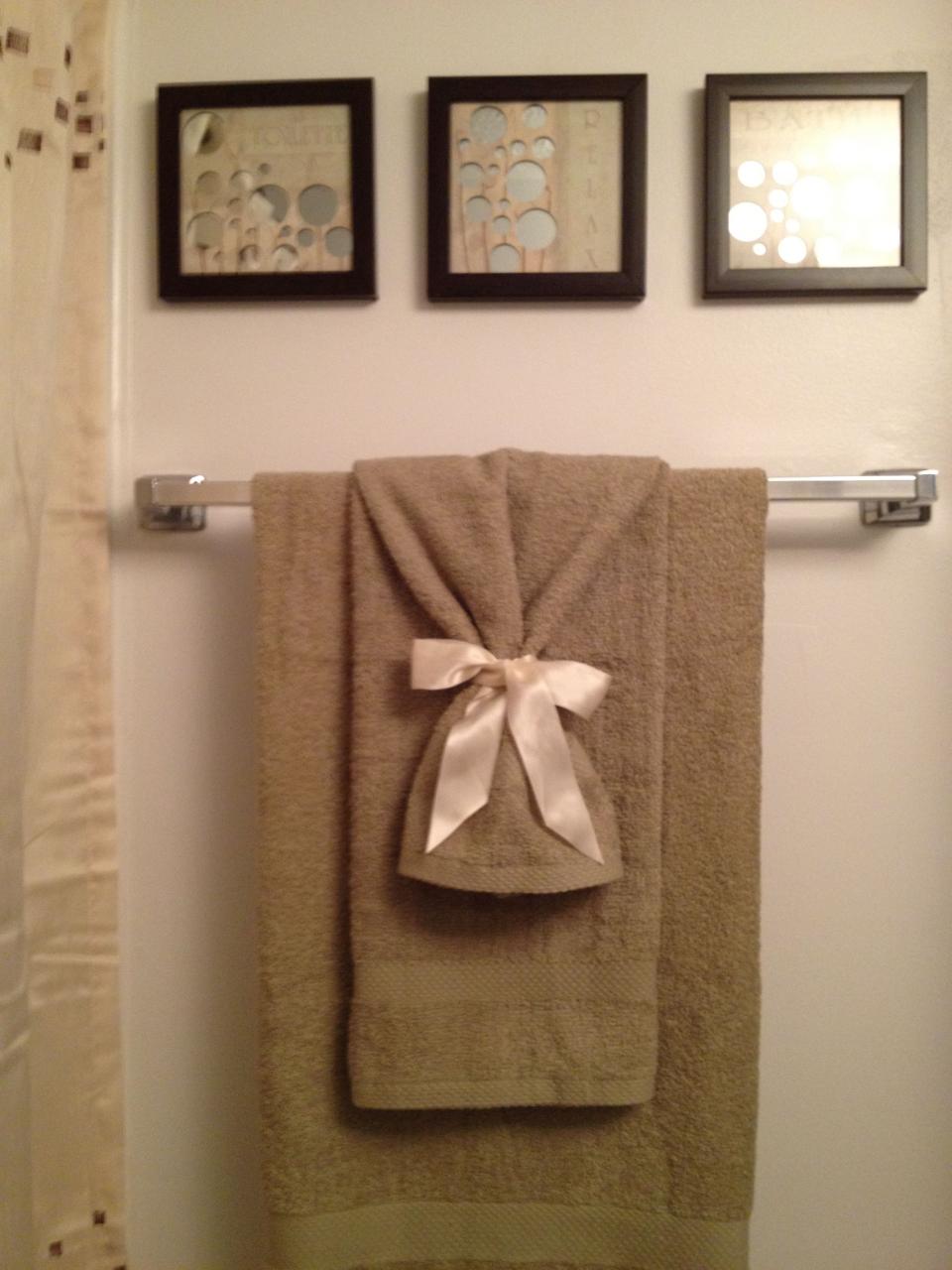 Use ribbon tied around towels ) Bathroom towel decor, Hang towels in