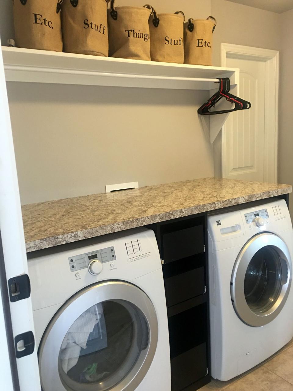 Laundry room with counter over the washer dryer, slide out drawers in