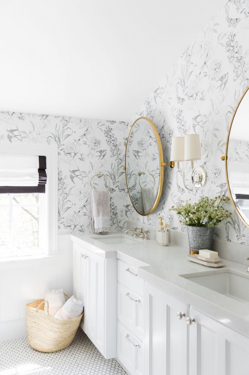 A whimsical, neutral kid's bathroom with mixed metals and wallpaper