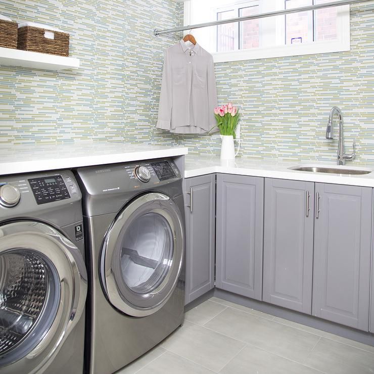 Green and gray contemporary laundry room is equipped with a silver