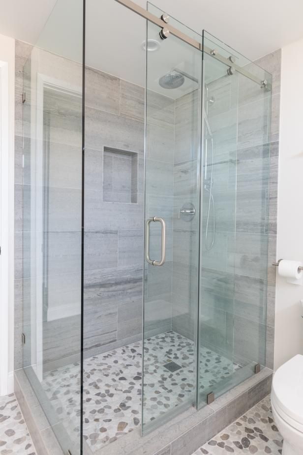 In this bathroom, a sliding glass shower door (instead of a swinging