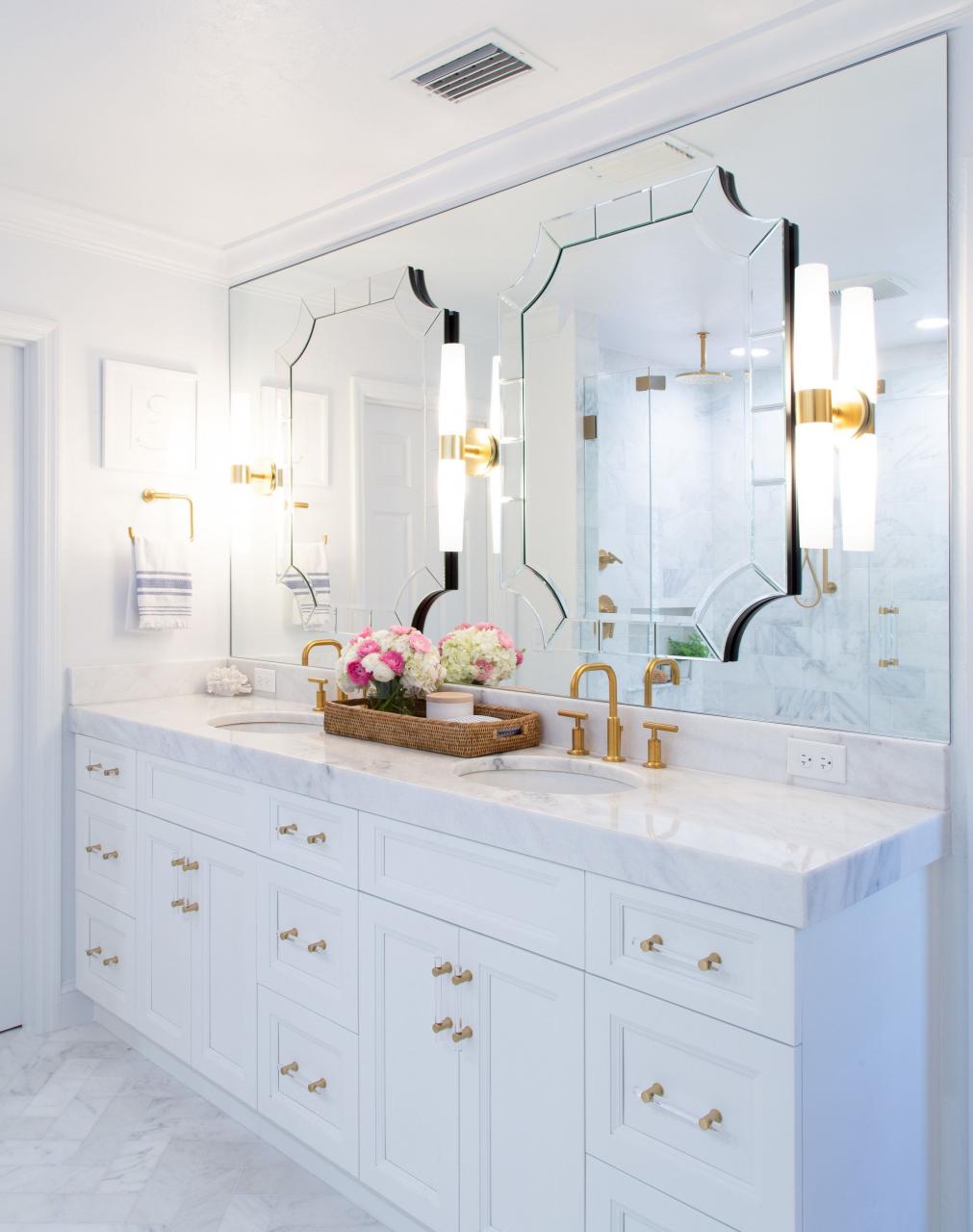 Full mirror wall behind the vanity with a pair of mirrors layered over