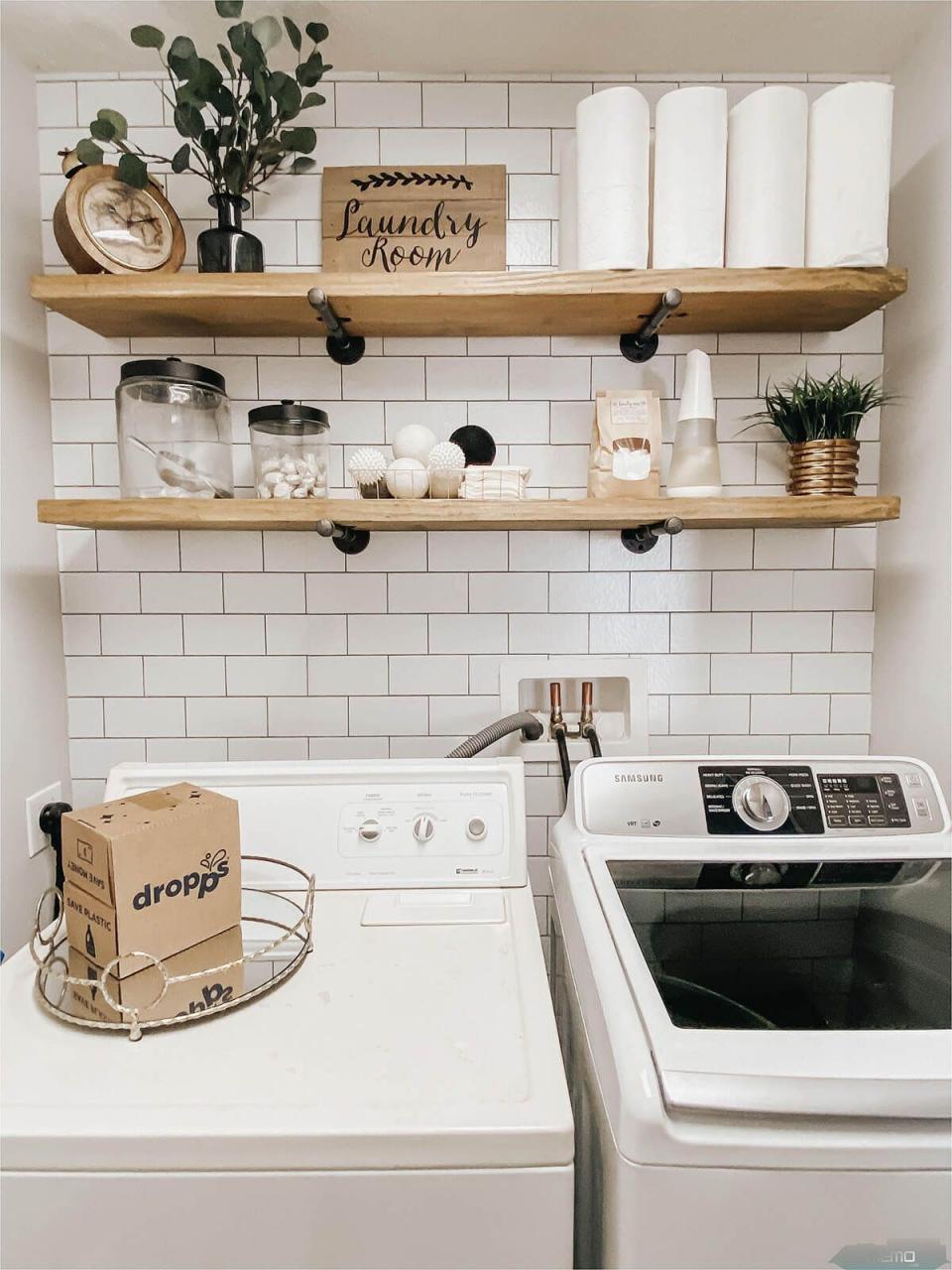 a white washer and dryer sitting next to each other in a room with open