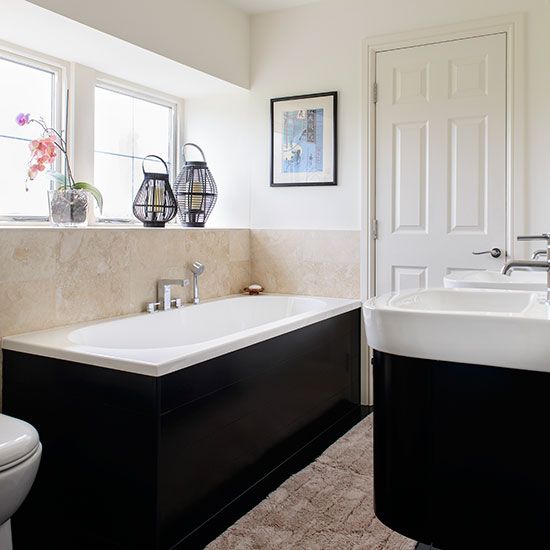 Cream bathroom with black bath and basin housing Bathroom decorating
