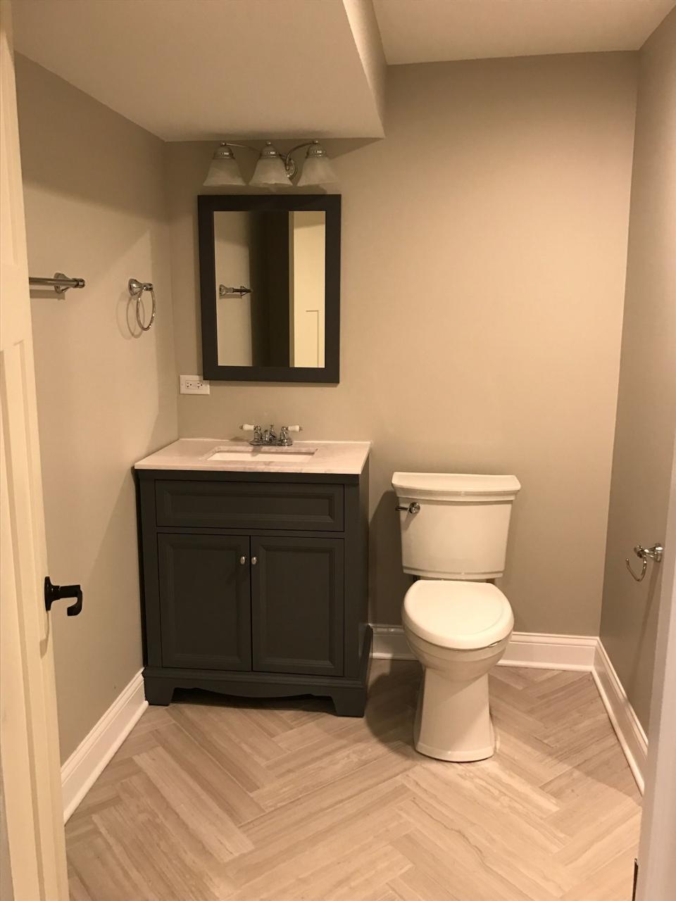 Bathroom with gray herringbone tile Agreeable Gray wall paint Gray