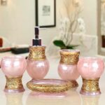 Adorable pink and gold bathroom accessory set for the bathroom in the