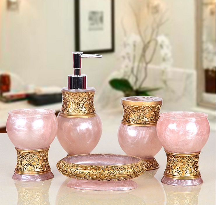 Adorable pink and gold bathroom accessory set for the bathroom in the