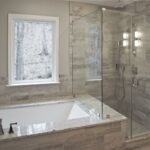 Bathroom remodel by Craftworks Contruction. Glass enclosed shower, drop