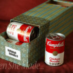 Reuse empty soda boxes to create handy storage for your canned goods
