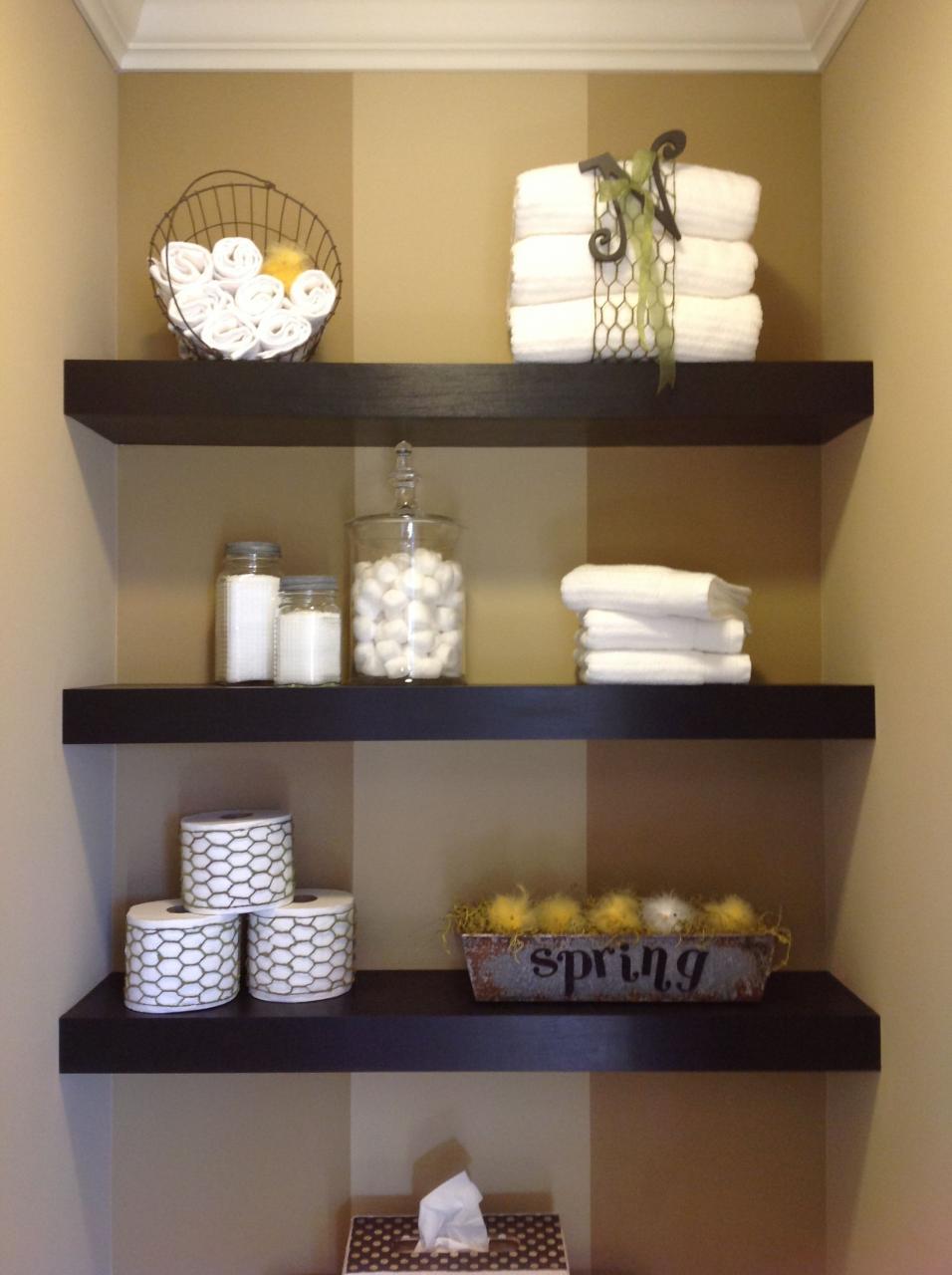 bathroom shelves with towels and baskets on them