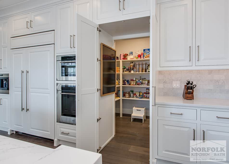a secret pantry hidden behind a door! White kitchen