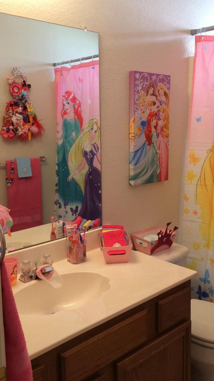 a bathroom with disney princess shower curtains and other items on the